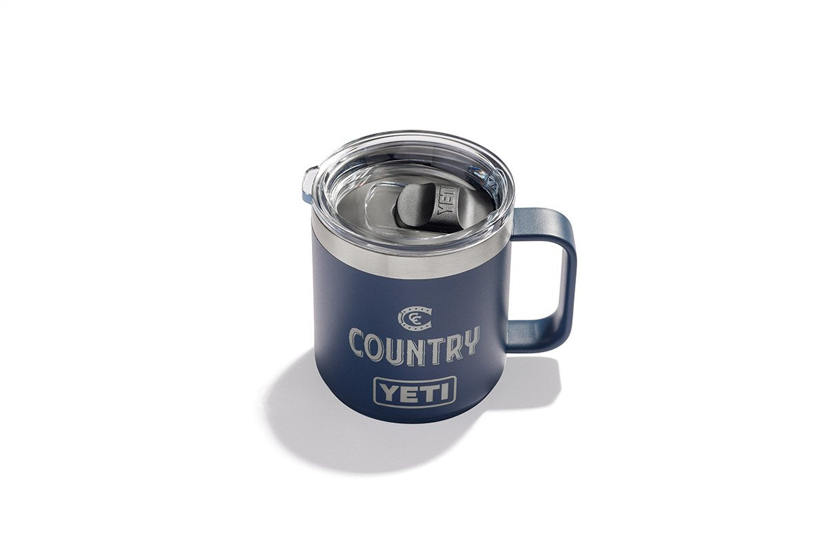 Dark blue Yeti 14oz mug that looks like a coffee cup. It has a lid on top so you don't spill and has Country with the logo etched into the side. 